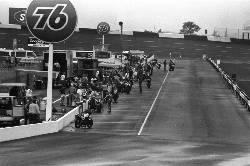 Rockingham WERA '86 Looking down pit road shot with a long telephoto lens at Rockingham before the start of a WERA National Endurance race. It graphically shows the wall that riders faced at top speed when racing through the first bowl turn. (Larry Lawrence photo)
