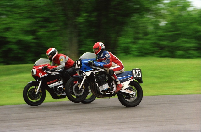 WERA racer Jon Joseph soars over the famous Grattan jump side by side with rider No. 170 in a WERA sprint race at the track in May of 1987. (Larry Lawrence photo)
