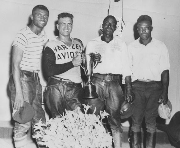 Payne trophy In the early 1950s Buster Payne (holding trophy) emerged from outlaw racing events, the only place black riders were allowed to race, to become the first known African-American rider to earn an expert license and compete in AMA Grand Nationals. Here Payne holds the winner’s trophy along with fellow racers after one of those non-sanctioned races. (Courtesy the Payne family collection)
