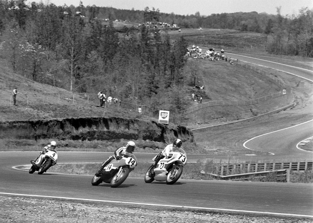 Turner201-sm Cal Rayborn on the No. 14 factory Harley-Davidson running side by side with Kel Carruthers on a factory Yamaha (No. 73. Following closely behind is Dick Mann on a factory BSA (No. 4). Carruthers won the race to give Yamaha its first AMA national road race victory. (Bud Turner Collection)