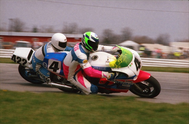 A WERA race at Indianapolis Raceway Park in April of 1992 with Dean Hayes on the DAK Racing Suzuki GSXR 750 or 1100 taking the inside line through IRP’s carousel. Carrying more momentum around the outside on his much nimbler handling Yamaha TZ250 is Al Hall. (Larry Lawrence photo)