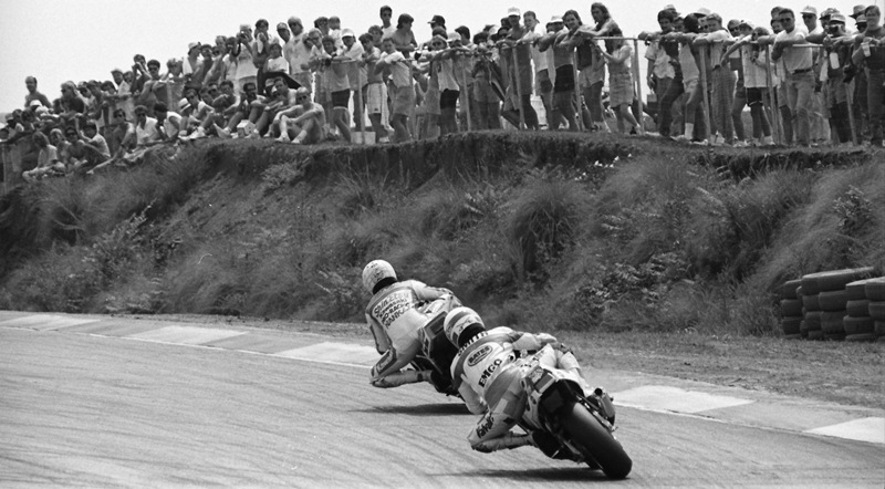 A crowd of 15,500 flooded Road Atlanta at the WERA Grand National Final in November of 1990, to watch their favorite son Scott Russell make a special appearance in Formula USA on his Muzzy Kawasaki Superbike. Here Russell leads fellow Georgia rider Mike Smith on the Valvoline Suzuki coming out of turn five with a standing room only crowd watching on. This was likely the biggest crowd to ever watch a WERA race. (Larry Lawrence photo)