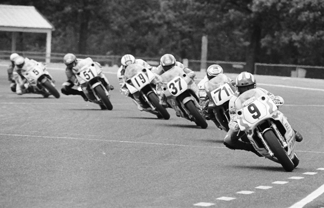 Suhonen, Jari - Brainerd WSBK '90 Jari Suhonen leads a pack onto the long front straight at Brainerd International Raceway in the American round of the World Superbike Championship on June 10, 1990. All the riders are trying to stand the bike up on the center of the tire as quickly as possible to obtain max acceleration out of the turn and onto the straightaway. (Larry Lawrence photo)