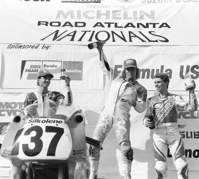 Ashmead, John - FUSA '93 John Ashmead stands atop the podium after the WERA Pro Formula USA race at Road Atlanta in May of 1993. Ashmead rode an N2 Racing Kawasaki ZX-7R Superbike to the overall victory with a 3-1 in the two F-USA legs. Ashmead beat out the 250 Grand Prix bikes of runner up Chris D’Aluisio (right) who raced a Southwest Motorsports Yamaha TZ250, and Rich Oliver, who took third on his Performance South Yamaha TZ250. (Larry Lawrence photo)
