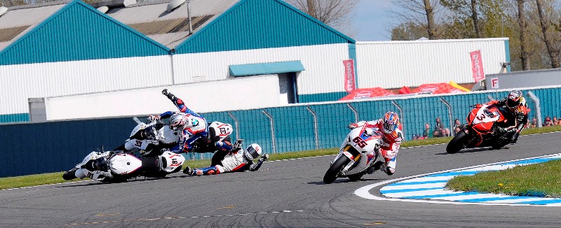 Donington_Melandri_Haslam_crash-sm Leon Haslam looked to have it won until both he and Marco Melandri ran wide as the Italian attempted a pass into the very last corner and Jonathan Rea pushed inside as a gap opened up. He and Haslam collided and Haslam fell, knocking off Melandri with his stricken bike as he slid across the track. Rea held on to win by just over half a second from Max Biaggi.