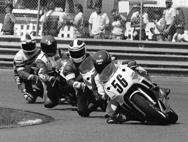 Pennington, James - Daytona '89 James Pennington leads a group of riders who appear to be auditioning for motorcycling’s version of the Blue Angels. The riders form a perfect formation as they race through the second horseshoe during the 1989 Daytona 600 Supersport race. (Larry Lawrence photo)