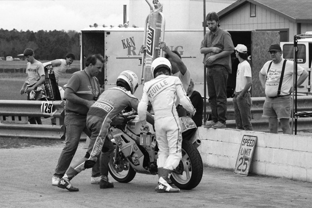 Kirk Reuille hands of the RAW Racing Yamaha FZR400 to Kevin Rentzell during the WERA National Endurance race at Roebling Road in March of 1990. (Larry Lawrence photo)