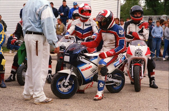 Zampach on 50cc Scott Zampach (on the Suzuki in the foreground) and other riders get ready for the big WERA mini-bike race at Blackhawk Farms Raceway in September of 1987. The mini-bike races were a fun diversion usually held at the end of Sunday’s races along pit road. (Greg Sickmeier photo)