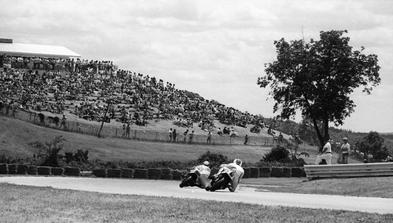 Elkhart 250GP - 1988 The picturesque environs of Elkhart Lake, Wisconsin’s Road America provide a pastoral backdrop for a motorcycle road race. Pictured is the AMA 250 Grand Prix final at Road America in 1988. A large crowd was on hand that day to take in the action. Many riders and fans consider the four-mile Road America their favorite road racing circuit in the U.S. (Larry Lawrence photo)