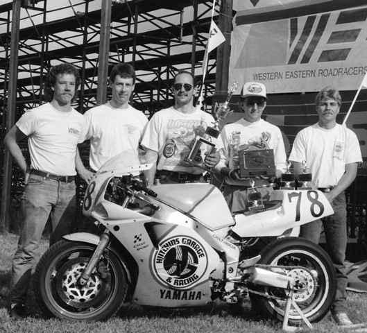 The Hutchins Garage Racing crew poses for a photo after taking third overall in the SBS/PM WERA Six-Hour National Endurance race at Seattle International Raceway in June of 1991. Hutchins Garage Racing was a local squad with Bruce Lind (wearing a hat) and Mark Haskins (second from the left) doing the riding. (Larry Lawrence photo)
