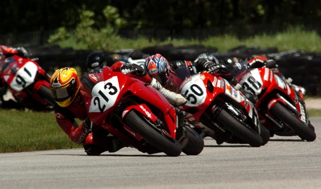 Tristan Schoenewald rides his Advanced Motion Controls Honda CBR600RR ahead of a mid-pack group that includes Giovanni Rojas (No. 50), Taylor Knapp (No. 38), and Jeffrey Tigert (No. 91) in the AMA Supersport final at Road America in June of 2005. (Larry Lawrence photo)
