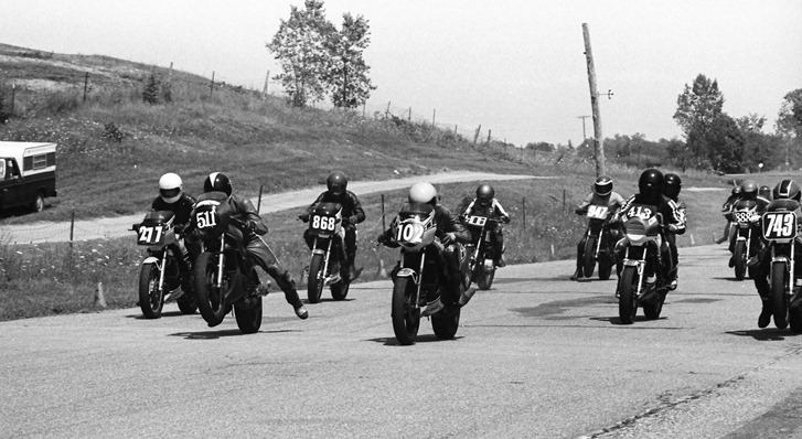 Barnard, Dave - Grattan 7-85 A talented group of novice riders throttle up at the start of a WERA D Superbike at Grattan Raceway in July of 1985. Dave Barnard (No. 511) wheelies his Yamaha alongside Chris Horn (No. 102). Barnard and Horn finished first and second in this race, just ahead of third-place rider Bob Meurer (No. 743). That’s future Superbike star Tom Kipp on the No. 868 Yamaha. (Larry Lawrence photo)