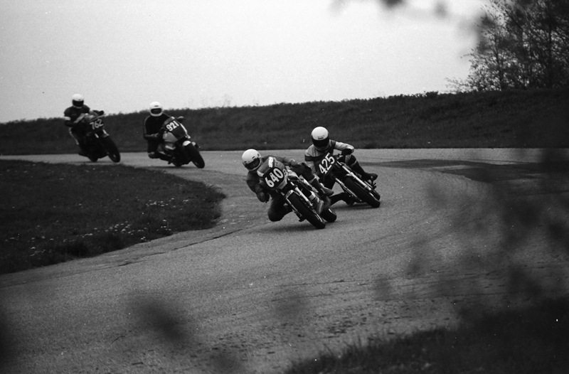 Berney, Brian on Callum Gray's Yam - Grattan 5-85 Callum Gray (No. 640), on his Yamaha LC350, leads a pack of riders in a WERA sprint race in May of 1985. This photo was shot among the trees that lined the outside of the track during the mid-1980s. You definitely didn’t want to run off the track in this section. Great for photography, not so much for the riders. (Larry Lawrence photo)