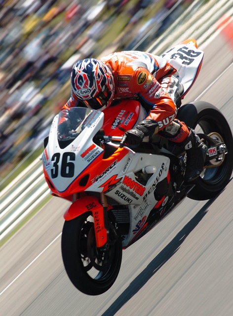 Wood, Eric - Barber 4-05 Eric Wood gets on the gas and wheelies his Hooters Suzuki GSXR1000 out of a turn during the Sunday AMA Superbike race at Barber Motorsports Park in April of 2005. (Larry Lawrence photo)