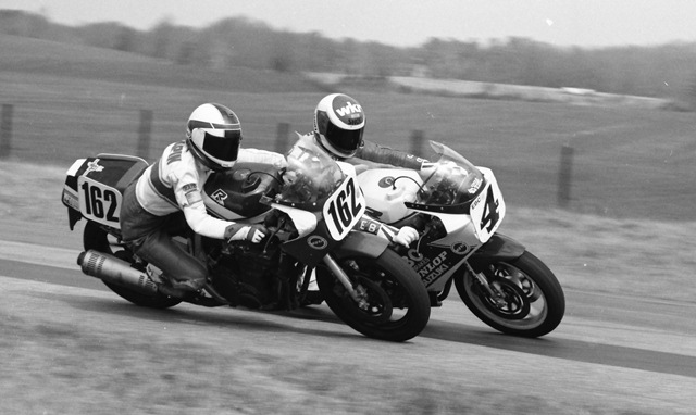 Russell, Scott - TGPR 3-88 Scott Russell, racing the Solmax Racing Suzuki GSXR1100, goes around the outside of another endurance racer (possibly John Taupin of Cycle Exchange Racing) during a WERA National Endurance race at Talladega Gran Prix Raceway in March of 1988. Russell led his team to victory. (Larry Lawrence photo)