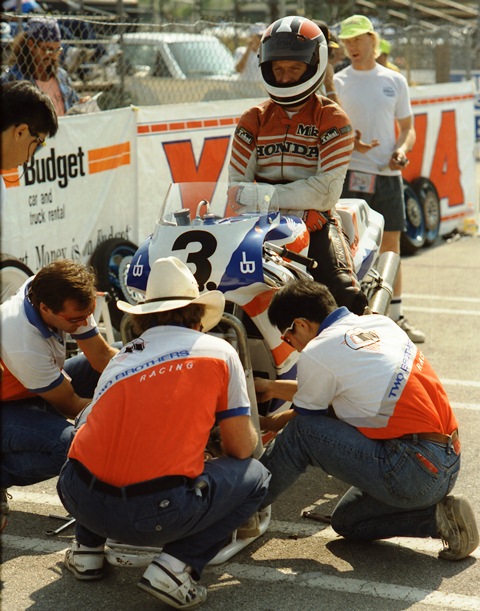 Baldwin, Mike - Miami 1991 Five-time AMA Formula One Champion Mike Baldwin sits on the Two Brothers Honda RC30 while the crew is hard at work during the Miami AMA Superbike event held on the streets of downtown in November of 1991. (Greg Sickmeier Collection)