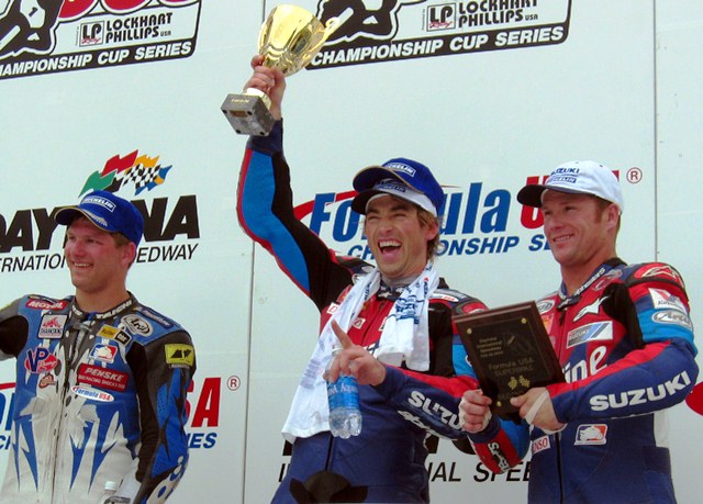 Haskovec - Daytona F-USA 2004 Valvoline Suzuki’s Vincent Haskovec (center) took the win in the F-USA Superbike final at Daytona in February of 2004. It was the first big outing for Haskovec with the Valvoline squad. He was joined on the podium by his teammate and second-place finisher Steve Rapp (right) and Robert Jensen (left) who was third. (Larry Lawrence photo)