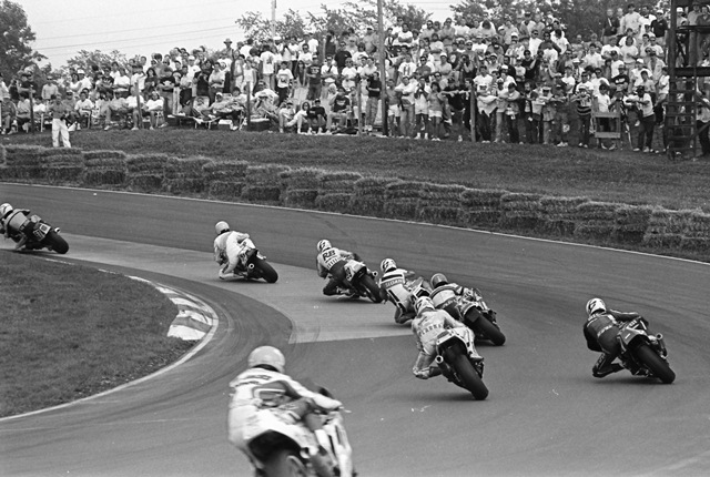 This photo from the 1990 AMA Superbike race at Mid-Ohio Sports Car Course clearly shows the famous natural amphitheater setting of the circuit’s turn five. This is the iconic viewing section at Mid-Ohio putting fans about as close to the Superbikes as any vantage point in the series. (Larry Lawrence photo)