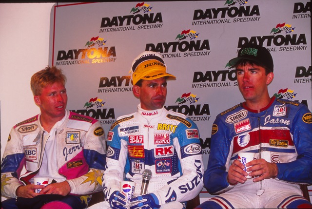 Rothman - Turkington - Pridmore (L to R) Gerald Rothman, Britt Turkington and Jason Pridmore in Daytona’s media center podium for the 1993 AMA 750 Supersport front-row qualifying press conference. There was a bit of a controversy after Turkington won the pole that year with a blistering pace of 1:56.872 on his Yoshimura Suzuki. ‘Turk’s’ time was not only a 750 Supersport track record, he shattered the previous year’s record set by Scott Russell by over a second and a half. He was also over a second and a half faster than second-place qualifier Rothman. While Turkington was a great rider at the peak of his game, there were questions flying about why he was so much faster than the rest of the field. His bike didn’t go through a post-qualifying tear down and fuel wasn’t tested. Yoshimura explained that Turkington was using a new generation of hollow tube needle jets in the carbs that improved atomization for a better fuel-air mix. In spite of the controversy Turkington’s Yosh Suzuki survived an extensive post-race teardown after he built a big lead and then backed off in the closing laps to win the race.