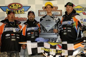 AMA Pro Racing GNC Short Track Team owner T.J. Burnett, crew chief James Hart, rider Brandon Robinson and team wrench Billy Gruwell celebrate on the podium after Brandon's break-out win in round 2 of the 2013 season at Daytona. Photo by Dave Hoenig/Flat Trak Fotos.com.