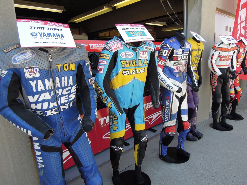 A display of some classic road racing leathers from Teknic displayed at the Red bull Indianapolis Grand Prix in 2011. The leathers (from left) are Tom Kipp’s 1993 AMA Superbike, John Reynolds’ 2004 British Superbike, Aaron Yates AMA Superbike, Miguel Duhamel’s 1995 and 1994 AMA Superbike leathers and Kurtis Roberts’ 2003 AMA Superbike. (Larry Lawrence photo)