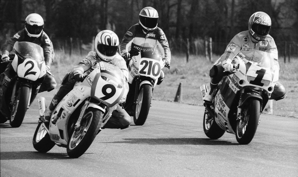Talladega Gran Prix Raceway is such a tight and technical little road race track that riders on nimble handling small bikes could often drive riders on bigger bikes nuts, as was the case here with Kevin Rentzell (No. 9), on the Raw Racing Yamaha FZR400, duking it out with Mike Smith (No. 1) on the Team Suzuki Endurance Suzuki GSXR1100 and Paul Bray (No. 2) on the Human Race Team Yamaha FZR1000. I think the other rider in the photo is David Mims on a Kawasaki EX500. (Larry Lawrence photo)