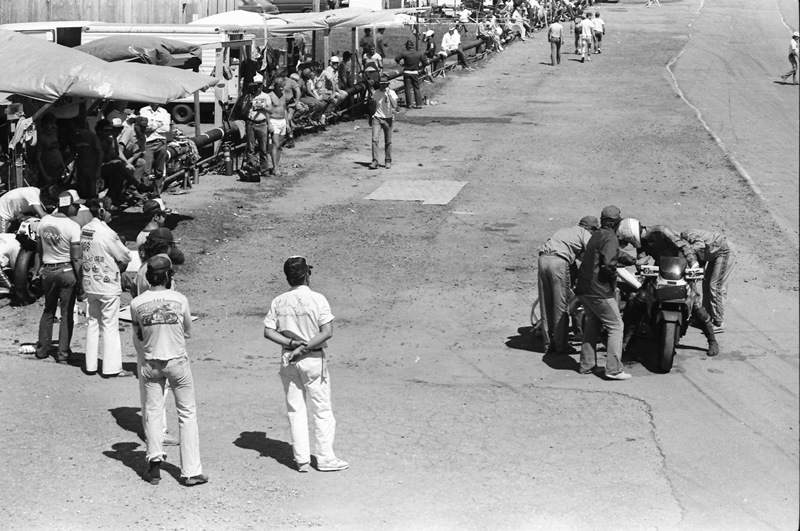 This overview shot from the 1985 24 Hours of Nelson Ledges endurance road race shows the somewhat crude or dilapidated state of the pits, near pit exit. (Larry Lawrence photo)