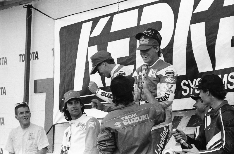 Mike Smith is all smiles as he’s being interviewed by announcer Glenn Billings on the podium after he and teammate Kurt Hall raced the Team Suzuki Endurance GSXR1100 to victory in the Kerker/SBS WERA National Endurance race at Willow Springs in April of 1990. (Larry Lawrence photo)