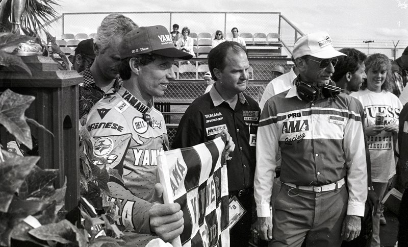 Eddie Lawson holds the winner’s checkered flag after taking victory aboard a factory Yamaha in the 1993 Daytona 200. That was the year that Lawson and Mr. Daytona, Scott Russell, had a last-lap duel for the ages. (Larry Lawrence photo)