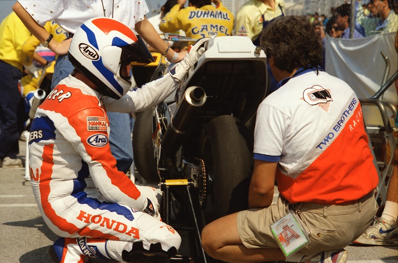 Freddie Spencer and his mechanic Mike Velasco look over the rear Michelin tire of the Two Brothers Racing Honda RC30 Superbike, possibly during a red flag break, at the Miami Grand Prix, the 1991 season finale AMA Superbike race on the downtown streets of Miami. Spencer went on to win the race. (Greg Sickmeier Photo)
