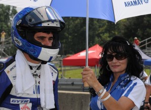 Tommy Aquino waits on the grid at Mid-Ohio in 2010, while his mom Carrie shields him from the sun. (Larry Lawrence photo)
