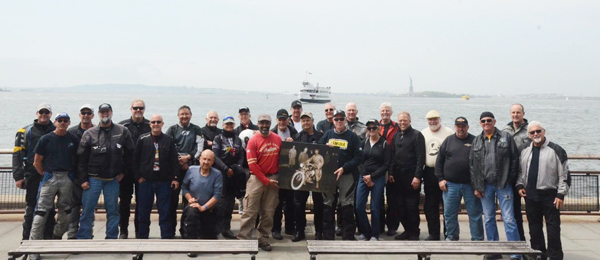 The cross country riders at Battery Park in NY with Lady Liberty in the background.