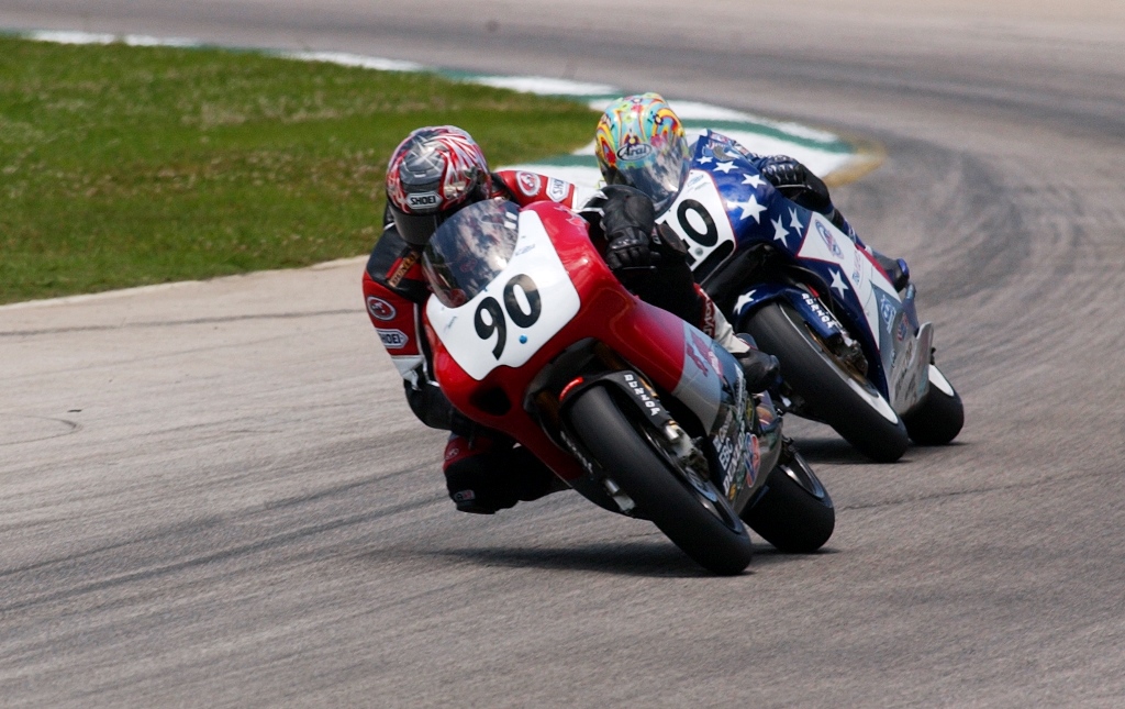 Chuck Sorensen (90) on the Team Stargel Aprilia, leads Jason DiSalvo (40) in an epic AMA 250 Grand Prix race at Road Atlanta in May of 2002. What I especially love about this photo is that it was a meeting of two different generations of riders. . Sorensen held off the young DiSalvo by 0.8 seconds to win the race. (Henny Ray Abrams photo)