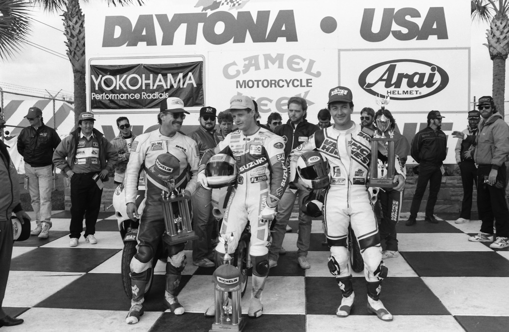Winner Jamie James (of Yoshimura Suzuki) celebrates his victory in the 1989 Daytona 750 Supersport race. He is flanked by second-place finisher David Sadowski (Vance & Hines Suzuki) and (in sunglasses) Mike Harth (Suzuki of Corpus Christi/Ronnie McIntyre/Michelin Suzuki). (Photo by Henny Ray Abrams)