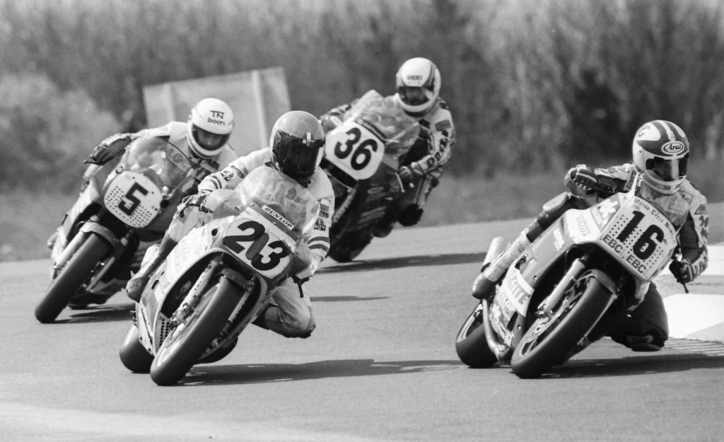 This photo shows action from the 1987 Match Races with Doug Polen (23), Keith Huewen (16), Trevor Nation (5) and Michel Mercier (36) battling it out, probably somewhere inside the top five. AMA rider Polen (5th ranked scorer) ended up being the top scorer of this group, followed closely by fellow AMA Superbike racer Mercier (6th), and BSB stars Nation (7th) and Huewen (9th). (Henny Ray Abrams photo)