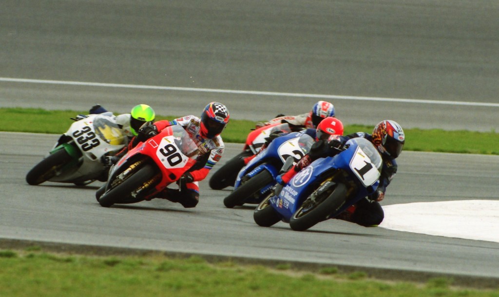 A photo showing the leading group of the AMA Mazda Truck 250 Grand Prix Series race at Pike Peak International Raceway on Sept. 18, 1999. 1998 series champ Roland Sands leads on his No. 1 Performance Machine Yamaha over Chuck Sorensen (No. 90), Randy Renfrow (No. 2), Quenni King (No. 333) and Jeff Vos (No. 7). Sands won the race. (Henny Ray Abrams photo)