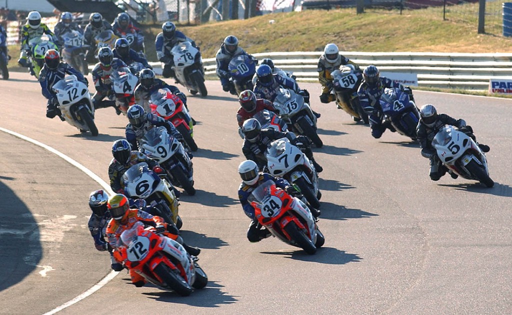 Larry Pegram (No. 72), on his Hooters/Mountain Dew Suzuki leads the pack into turn one at Mosport Park in Bowmanville, Ontario, Canada, in the July 2002 Formula USA race at the iconic Canadian circuit. Craig Connell (No. 6) on the Arclight Suzuki won the race. (Henny Ray Abrams photo)