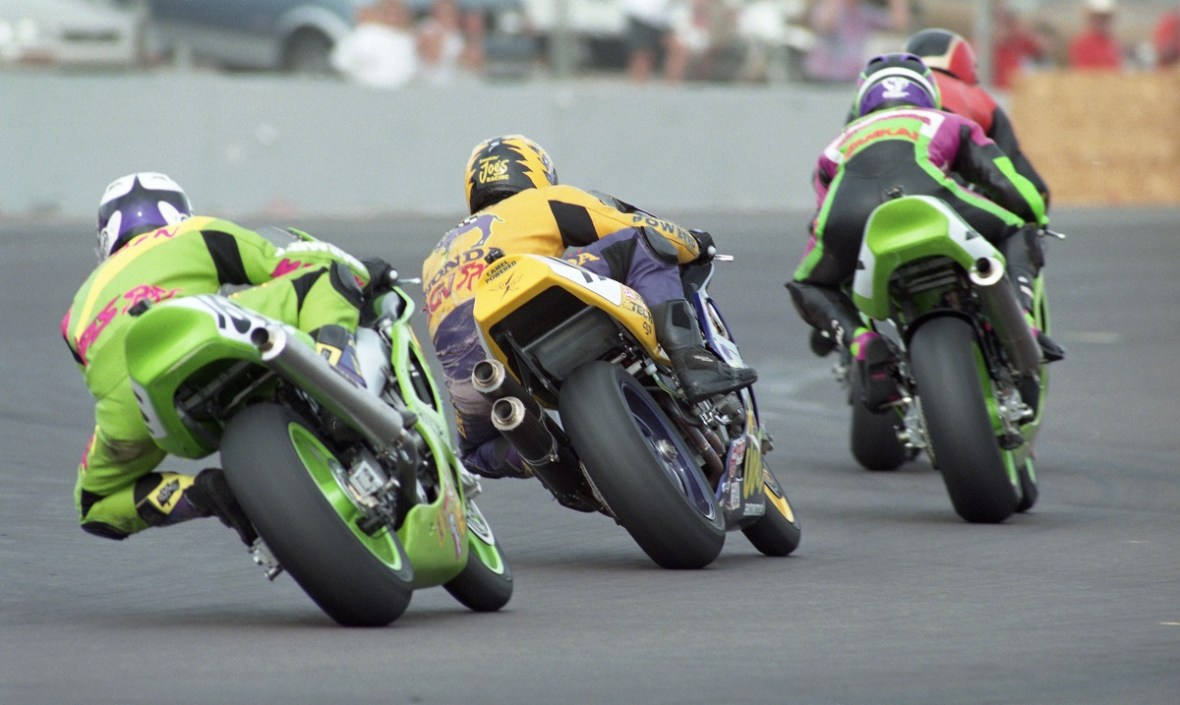 This Henny Ray Abrams photo shows the last lap of round one of the AMA Superbike race at Phoenix International Raceway on Feb. 16, 1997 with Tommy Hayden (Kawasaki ZX-7R) chasing Miguel Duhamel (Honda RC45), Doug Chandler (Kawasaki ZX-7R) and Tripp Nobles (Harley-Davidson VR1000). (Henny Ray Abrams photo)