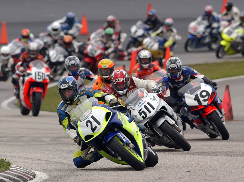 Scott Greenwood got the jump on the rest of the field in a Formula USA 600 Sportbike race at New Hampshire Motor Speedway in June of 2002. Greenwood (No. 21 Suzuki GSX-R600) leads Tim Bemisderfer (No. 511 Honda CBR600F4i) and pole winner Jeff Wood (No. 19 Suzuki GSX-R600). (Henny Ray Abrams photo)
