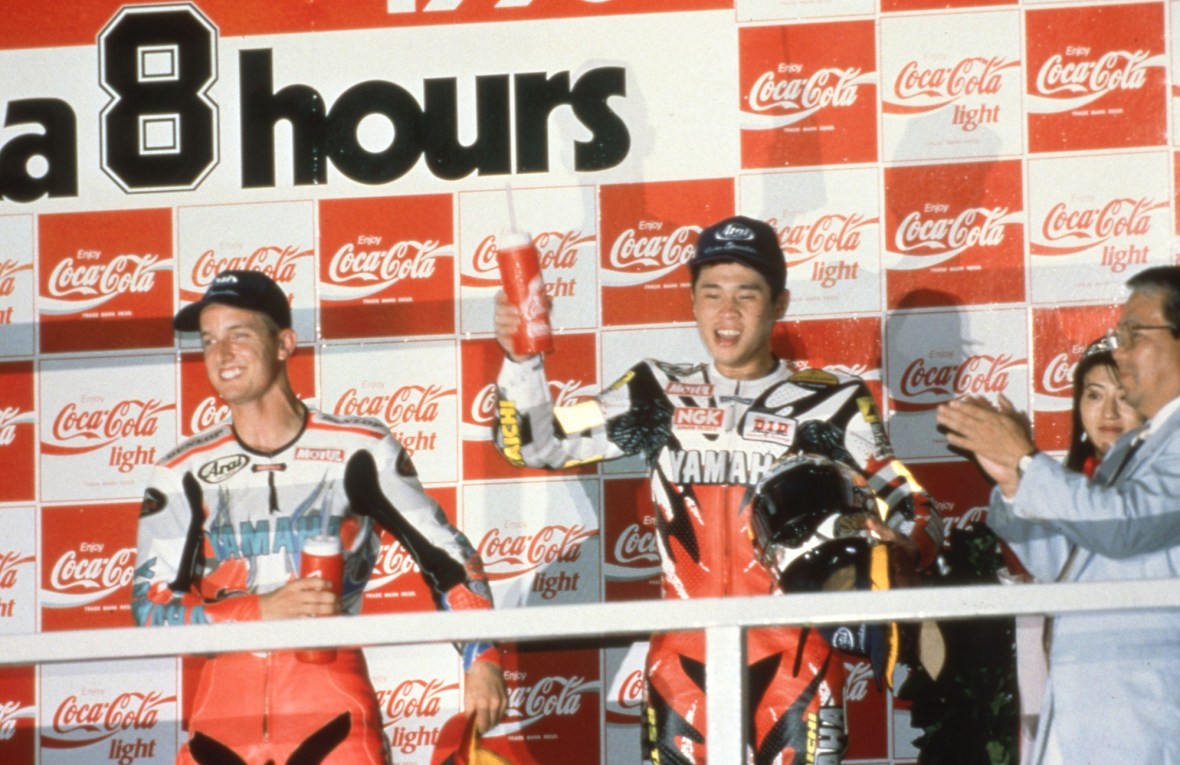 What do you get when you mix a Texas Tornado with Nitro Nori? You get the winners of the 1996 Suzuki 8 Hour. Colin Edwards and Noriyuki Haga celebrate winning the prestigious race riding a factory Yamaha YZF750. It marked the first big international victory for Haga and served as a springboard to a long and illustrious World Superbike career. (Courtesy Yamaha WSBK)