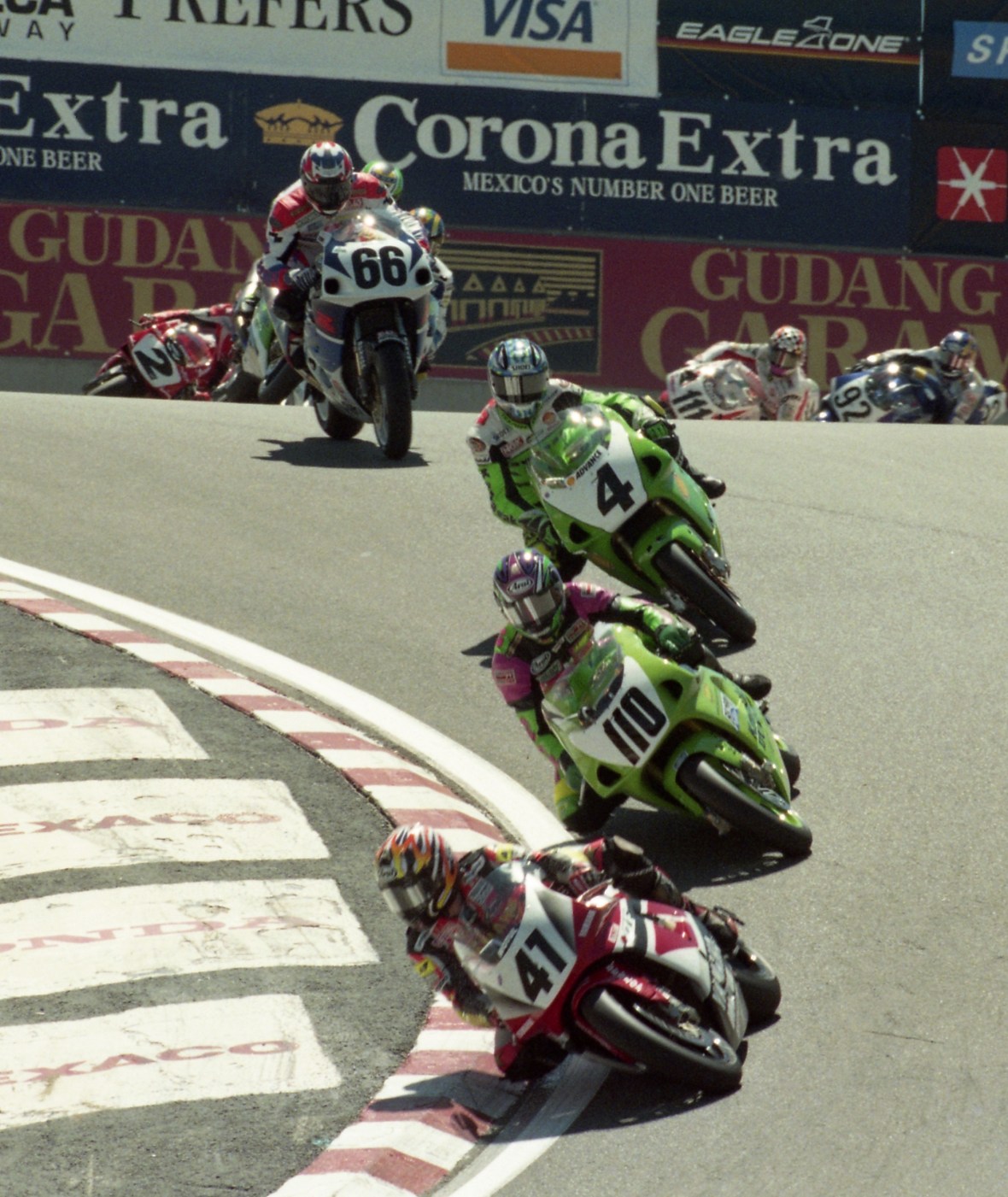 Yamaha’s Nori Haga leads a talented group of riders through the Corkscrew in the 1998 World Superbike Championship round at Laguna Seca Raceway. Giving chase to Haga in race one are Doug Chandler (No. 110), Akira Yanagawa (No. 4), Mat Mladin (66), Carl Fogarty (2), Aaron Slight (No. 111) and Jamie Hacking (No. 92).  (Henny Abrams photo)